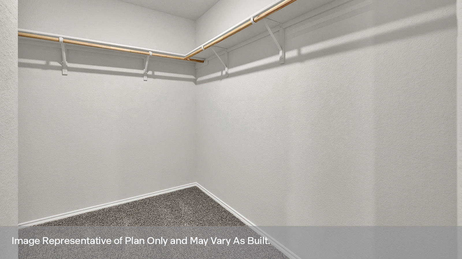 Main bedroom closet with carpeting and wooden shelving.
