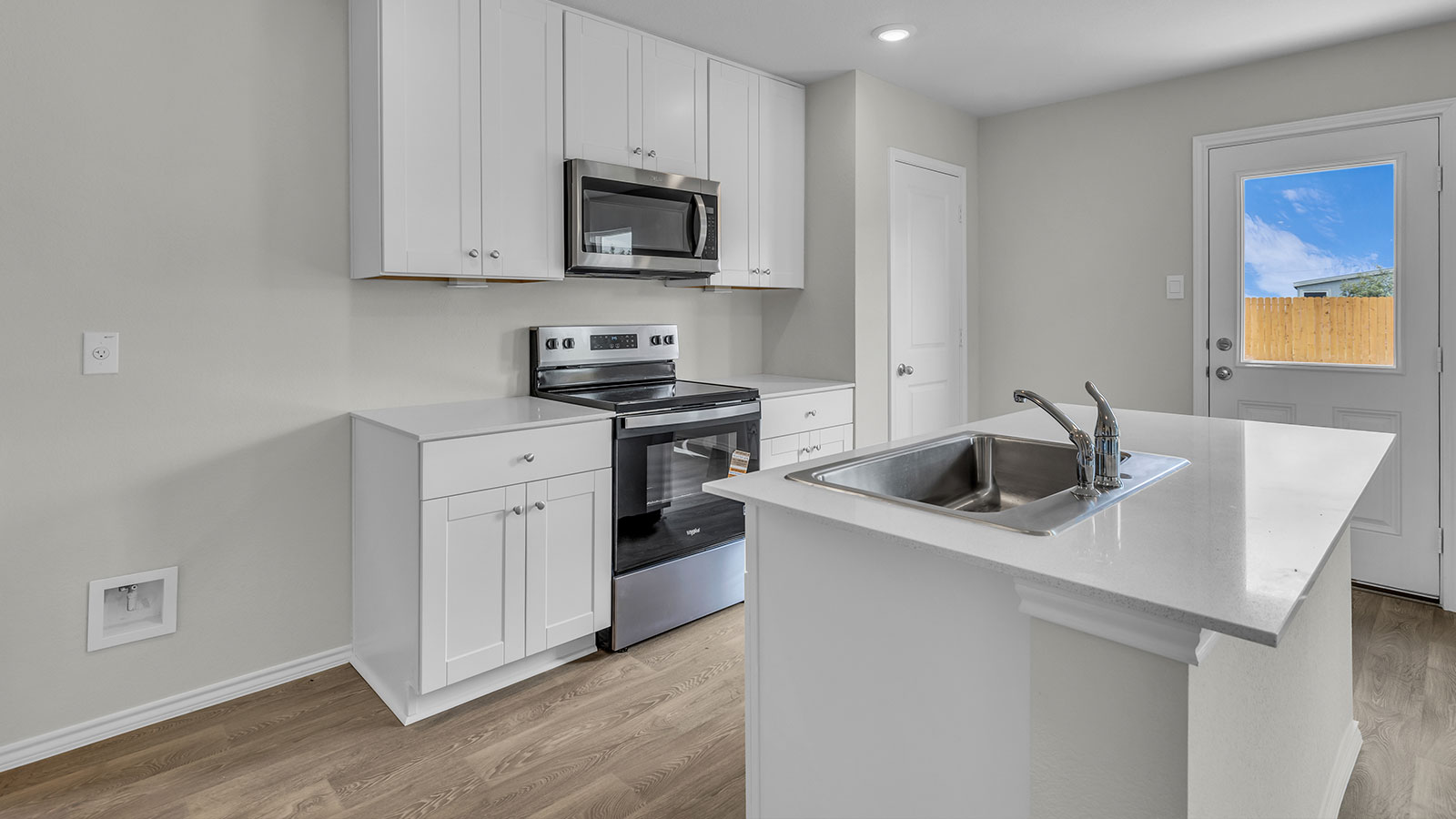 Kitchen with kitchen island and quartz countertop.s.