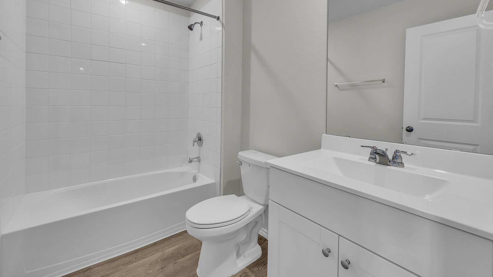 Hall bathroom with vanity, toilet, and tub.
