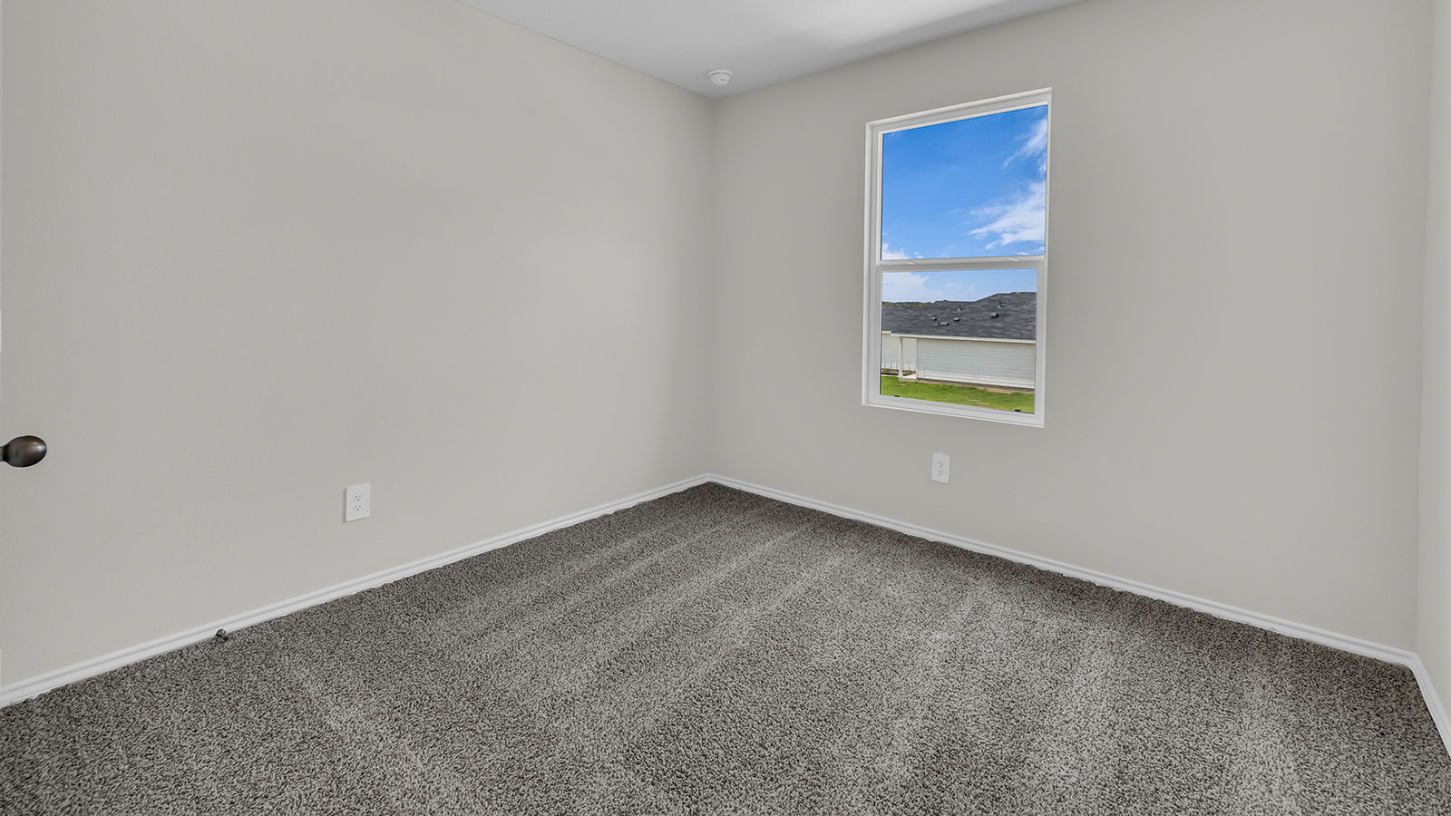 Secondary bedroom with carpeting and one window.