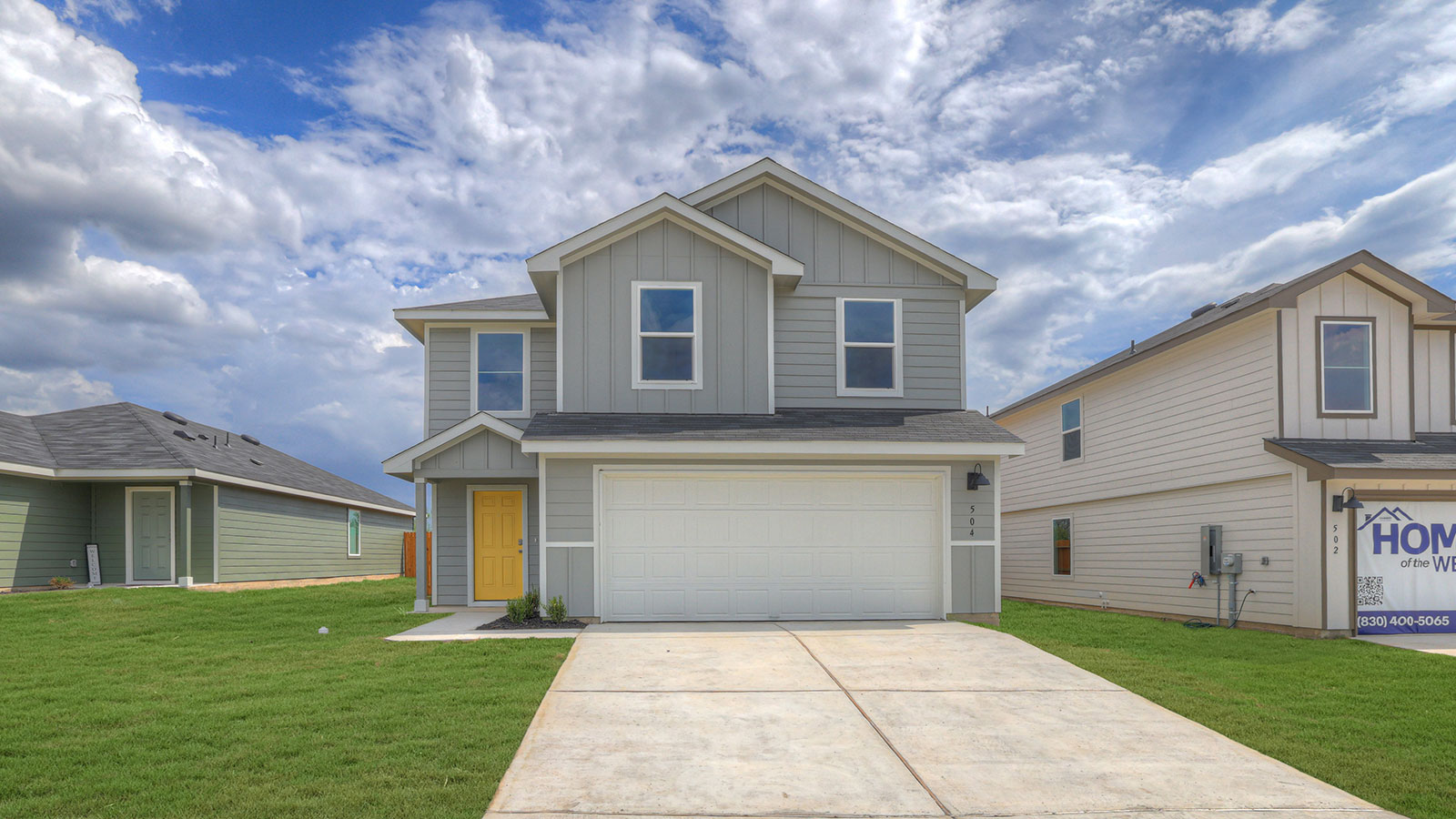 Two-story farmhouse exterior photo with 2 car garage.