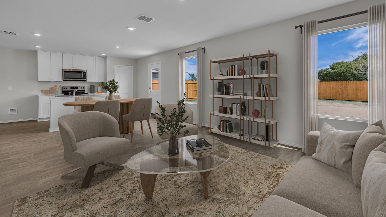 Living room and dining room staged with furniture.