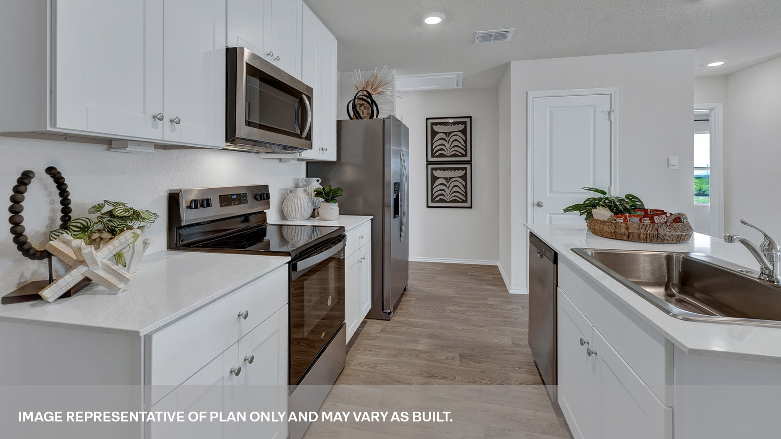 Kitchen with quartz countertops and stainless-steel appliances.