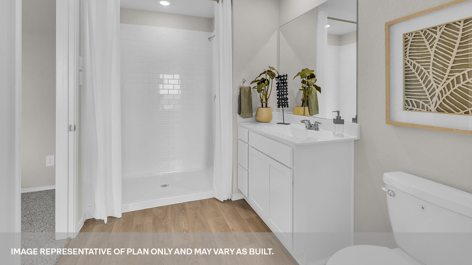 Main bathroom with toilet, walk-in shower, and vanity.