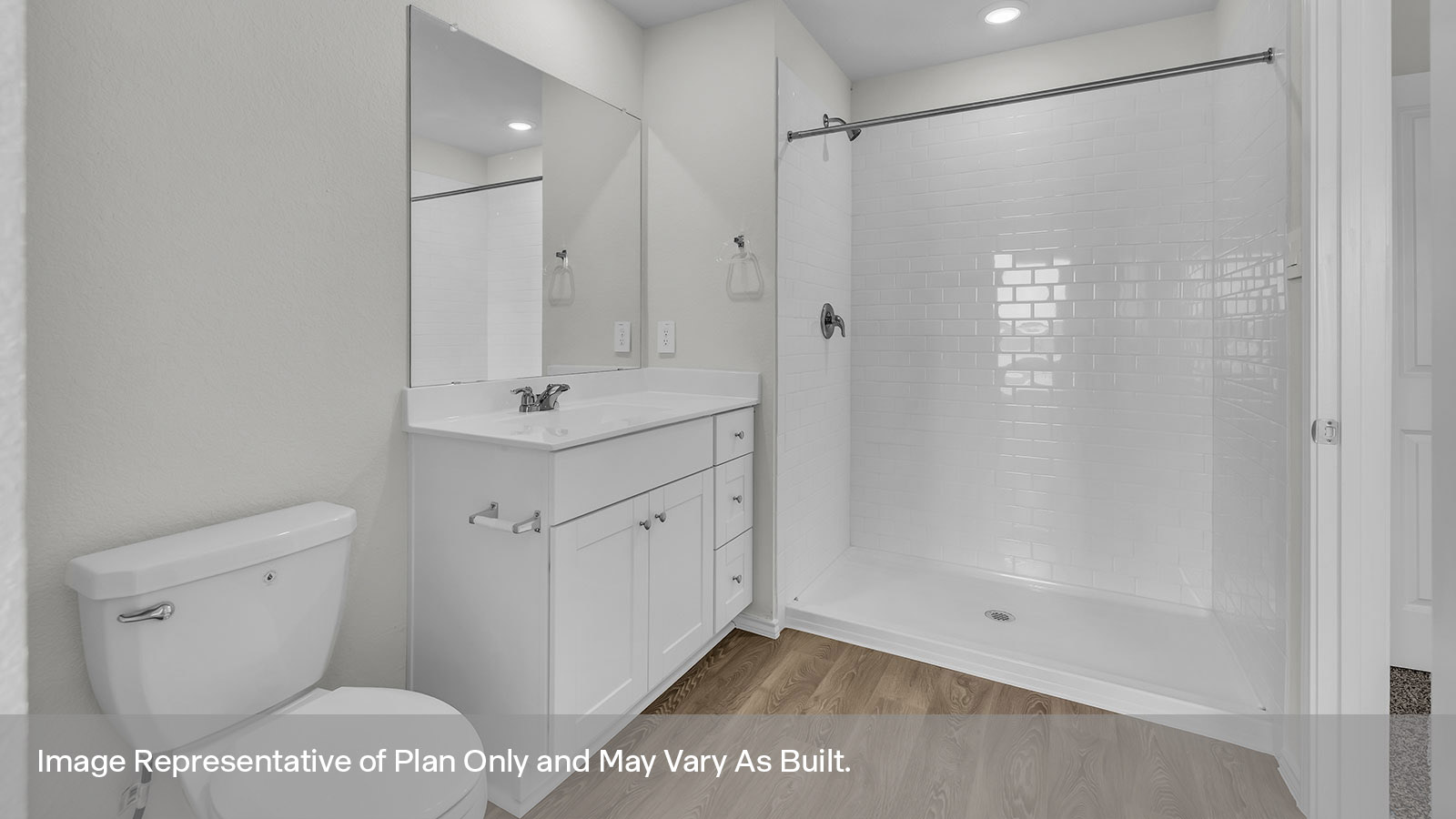Main bathroom with toilet, walk-in shower, and vanity.