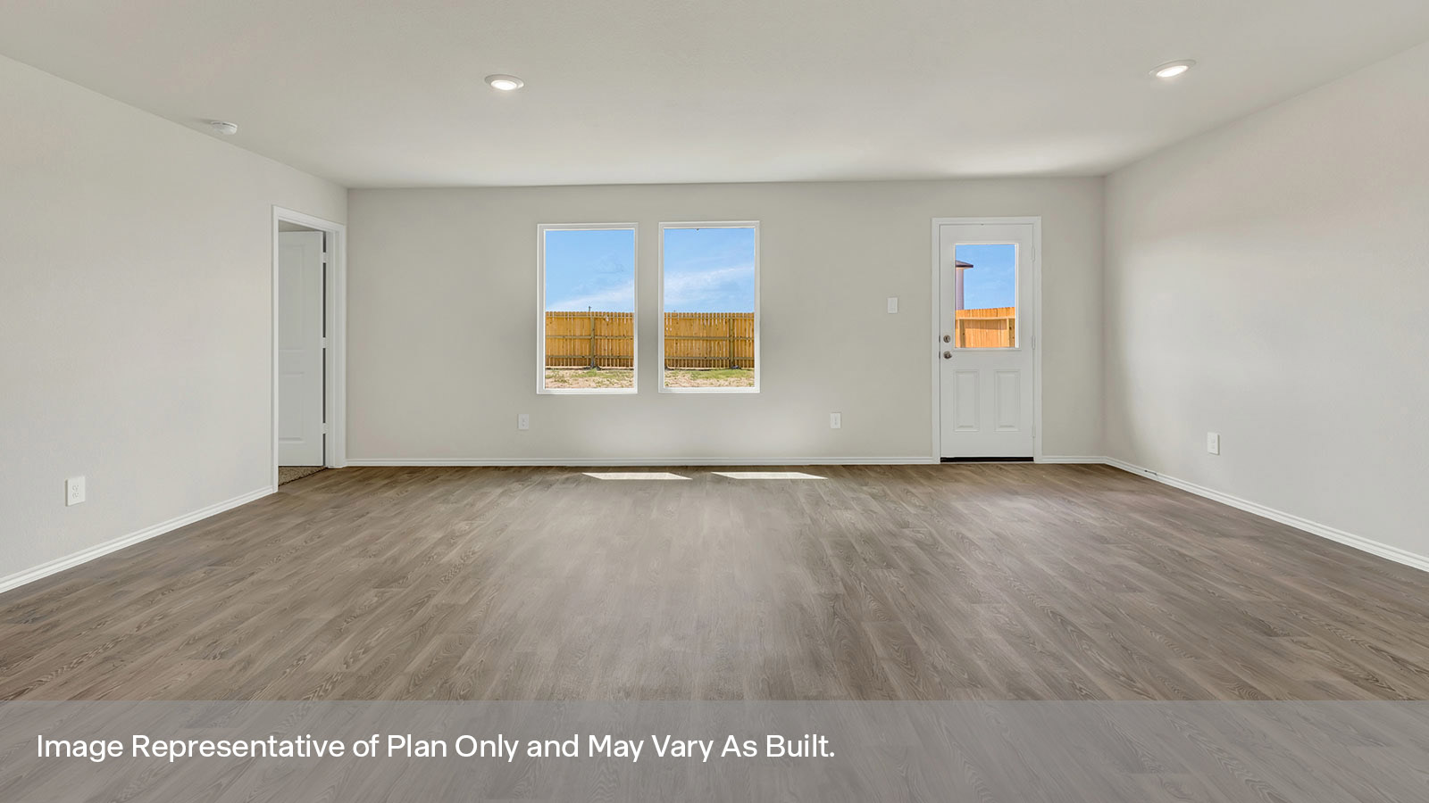 Living room and dining room with vinyl flooring, two windows, and a half lite exterior door.