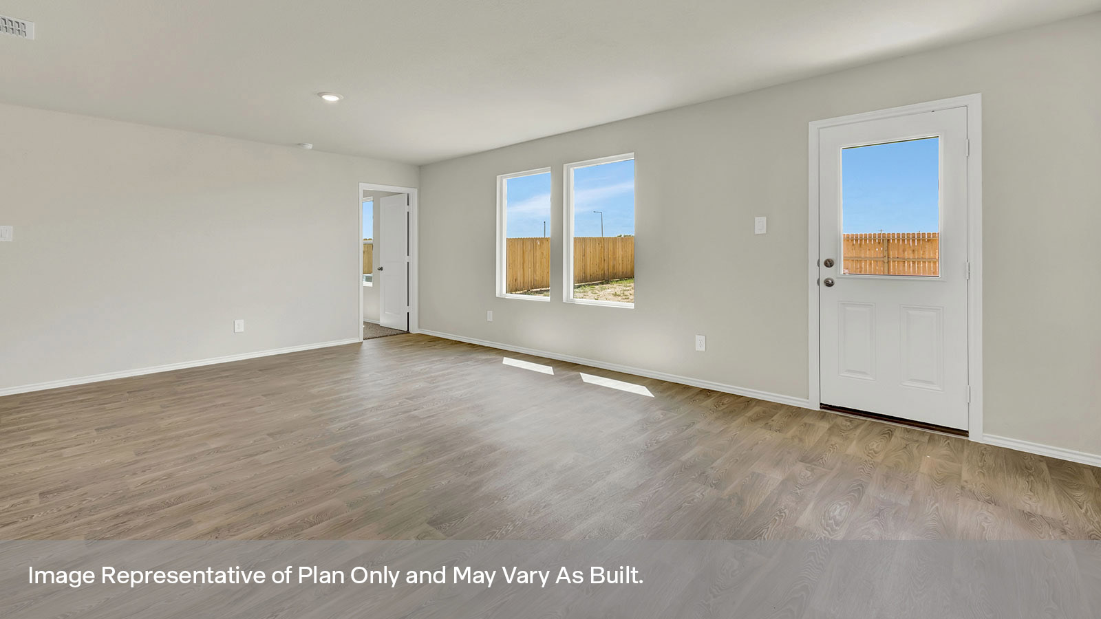 Living room with vinyl flooring, 2 windows, and a half lite exterior door.