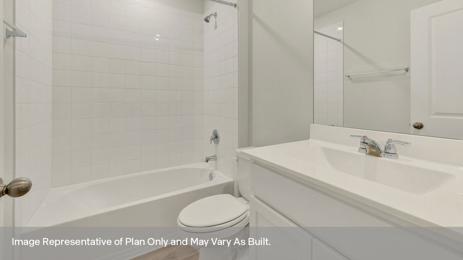 Hall bathroom with vanity, toilet, and tub with tile surround.
