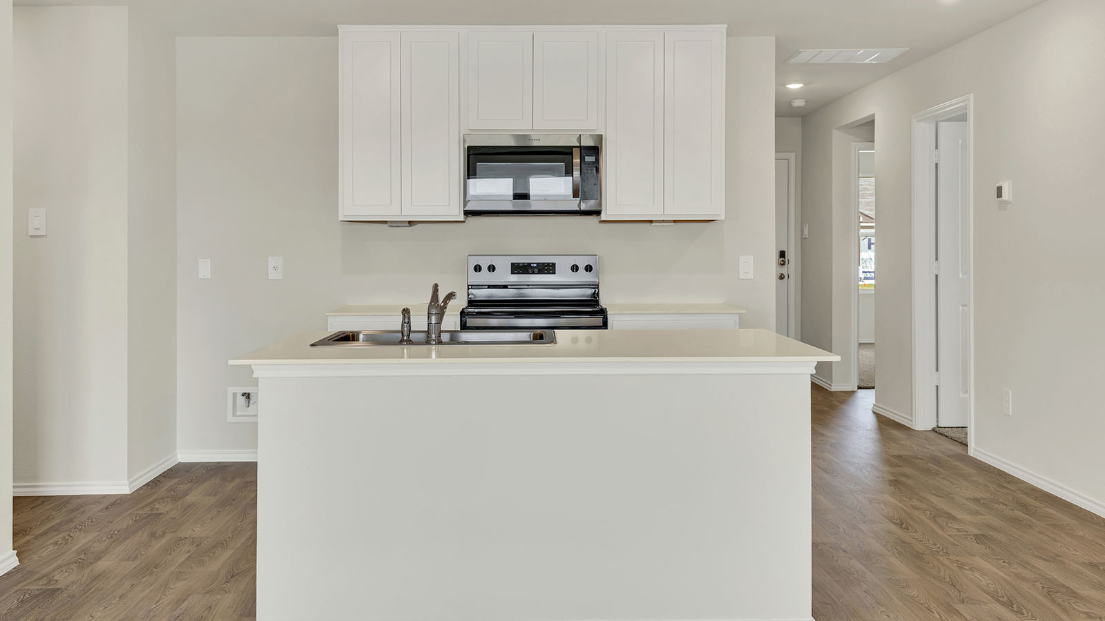 Kitchen with quartz countertops and stainless steel appliances.