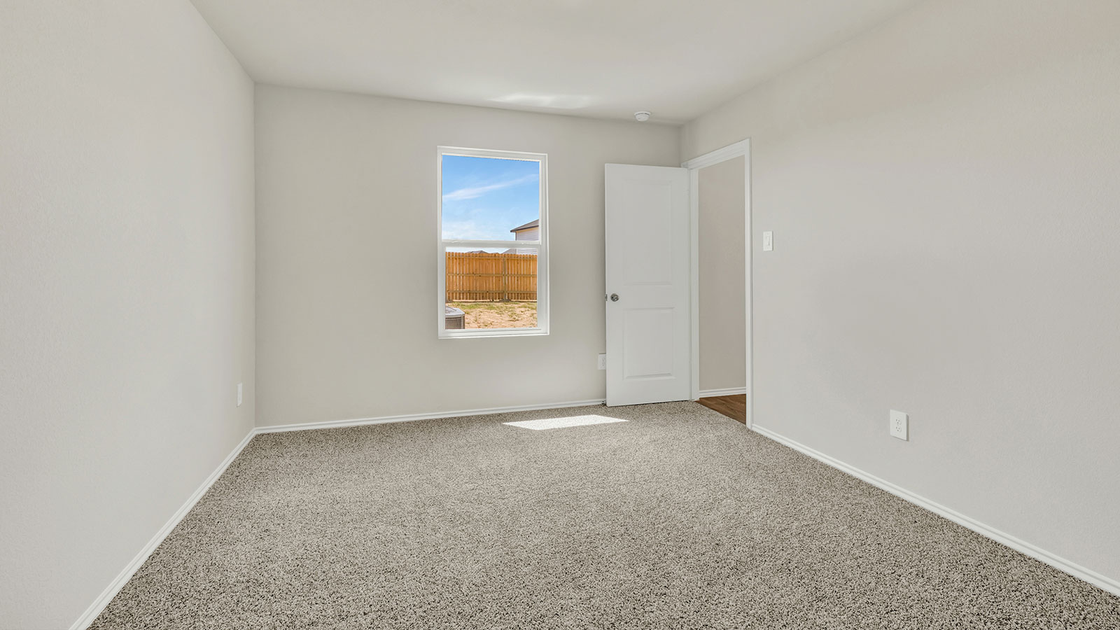 Main bedroom with carpeting and one window.
