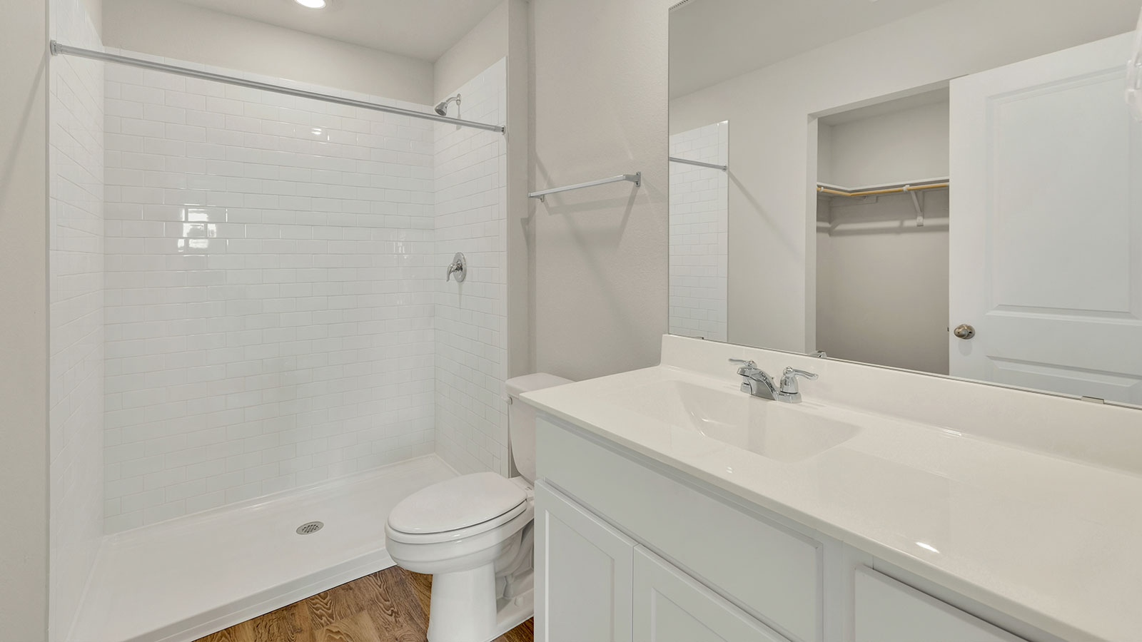 Main bathroom with vanity, toilet, and shower.