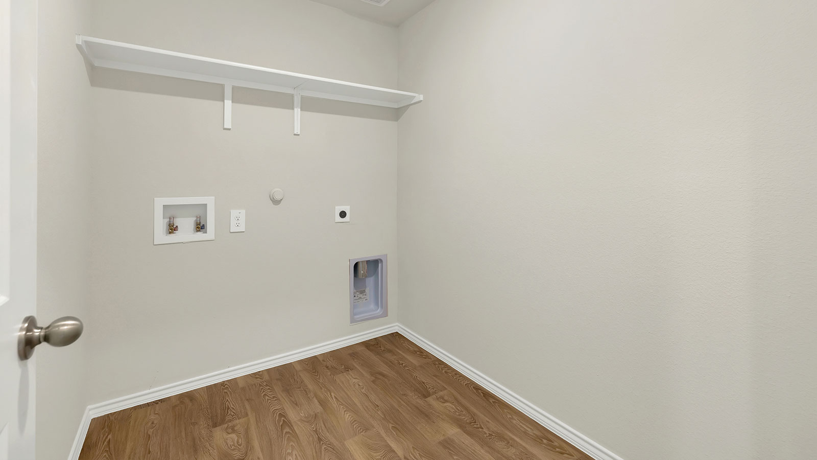 Laundry room with washer/dryer connections and wooden shelving.