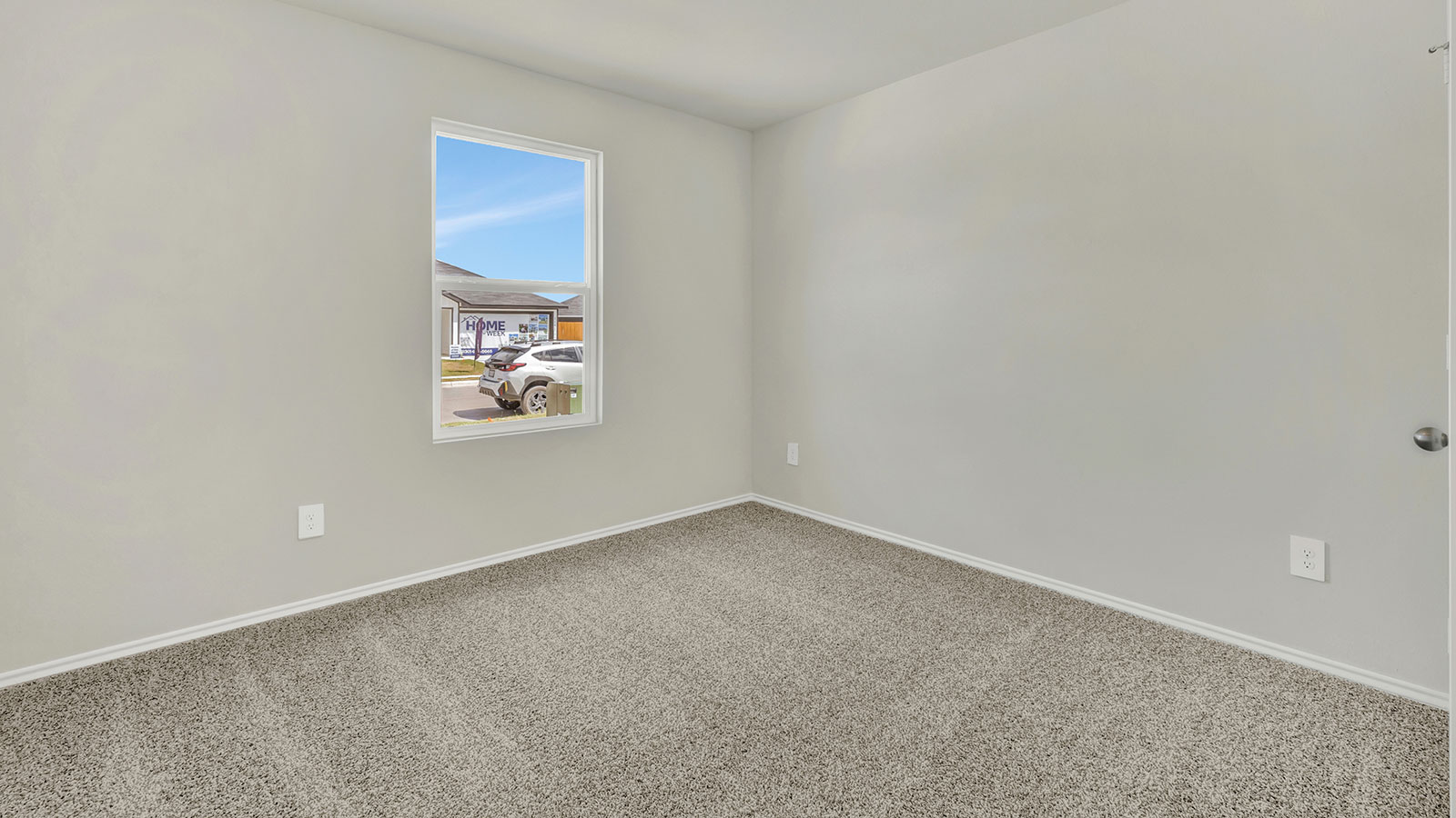 Front bedroom with carpeting and one window.