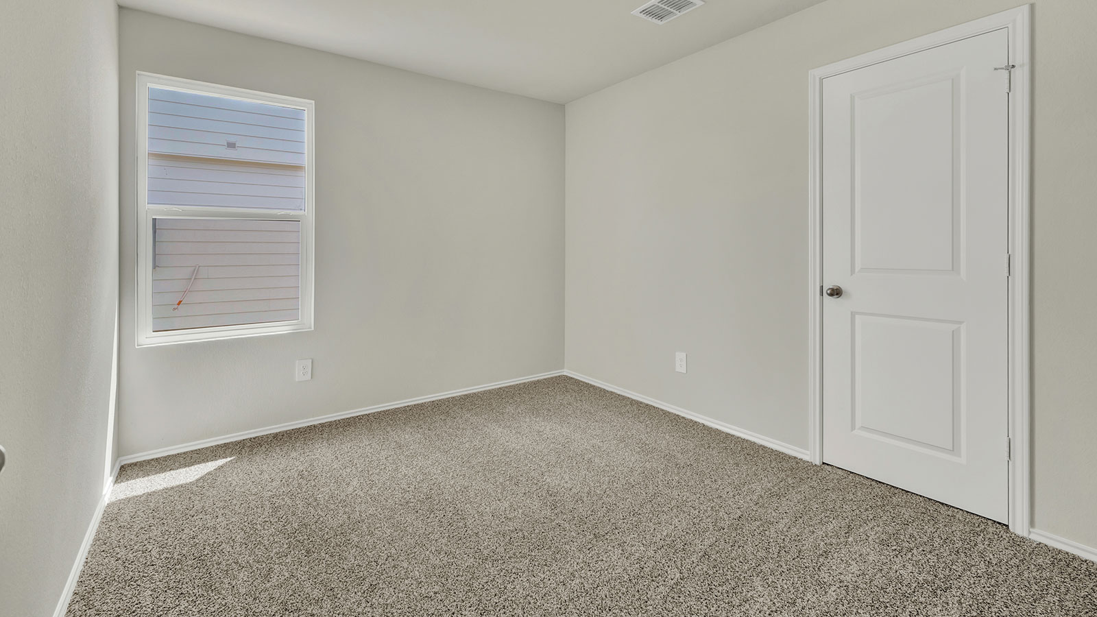 Secondary bedroom with carpeting and one window.
