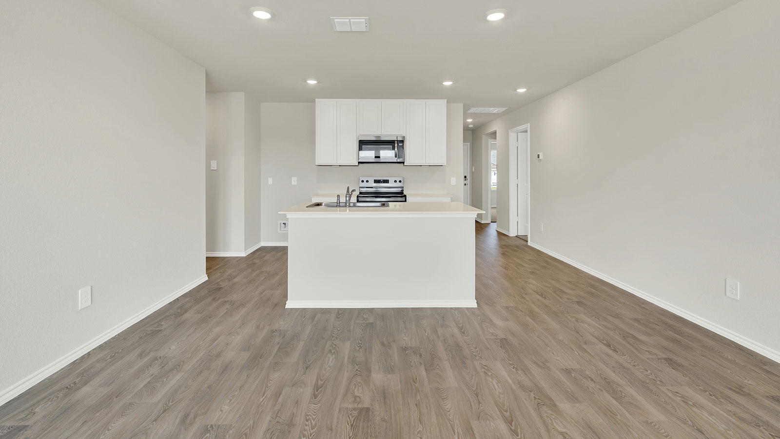 Kitchen with kitchen island and white cabinets.