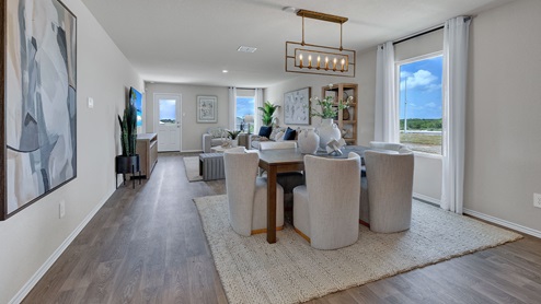 Dining room with vinyl flooring and one window.