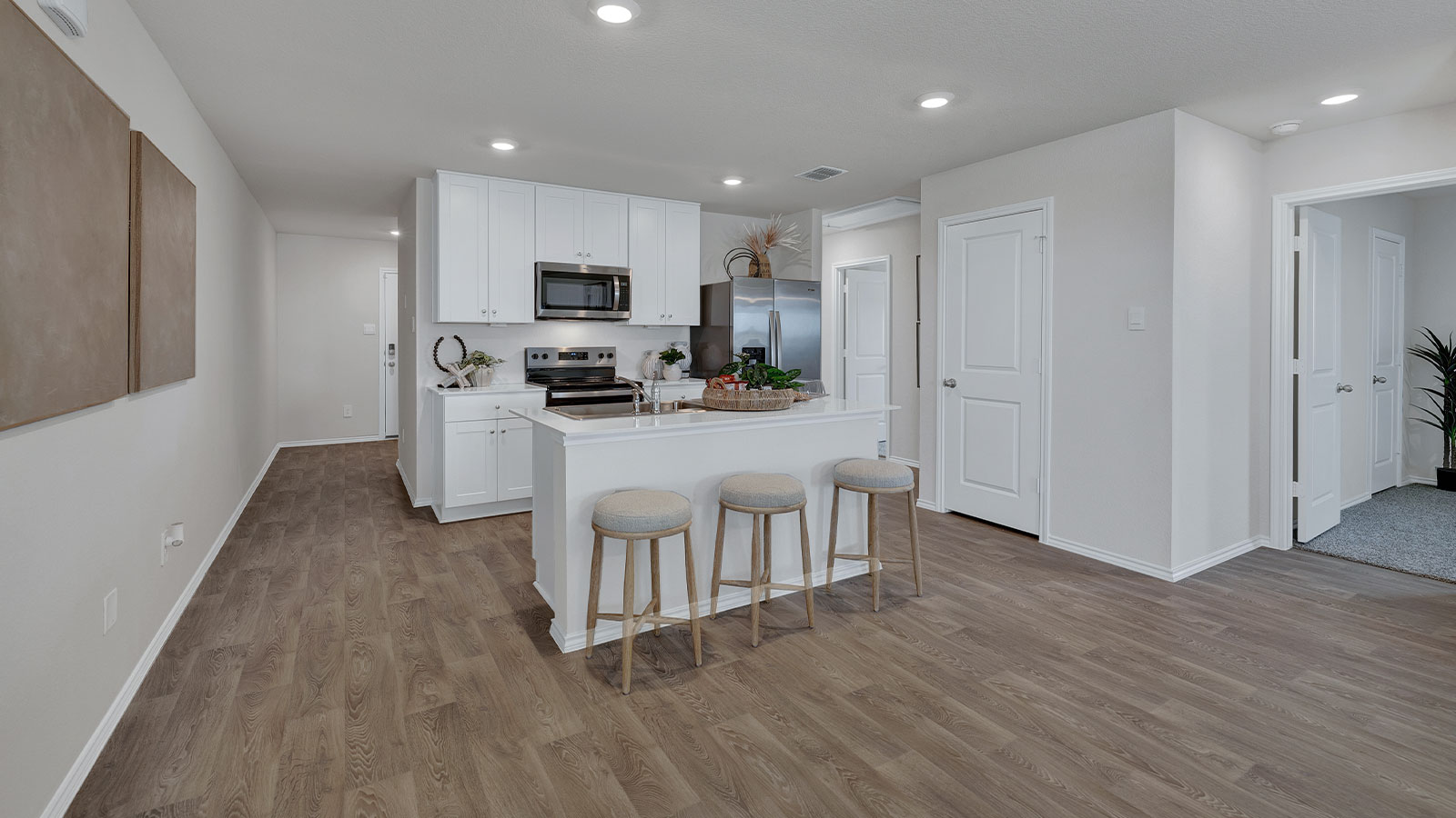 Entry hallway leading to kitchen with kitchen island.