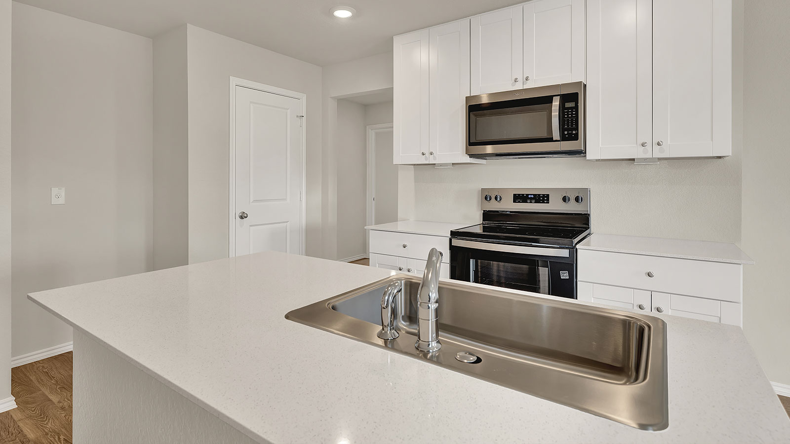 Kitchen with kitchen island and quartz countertops.