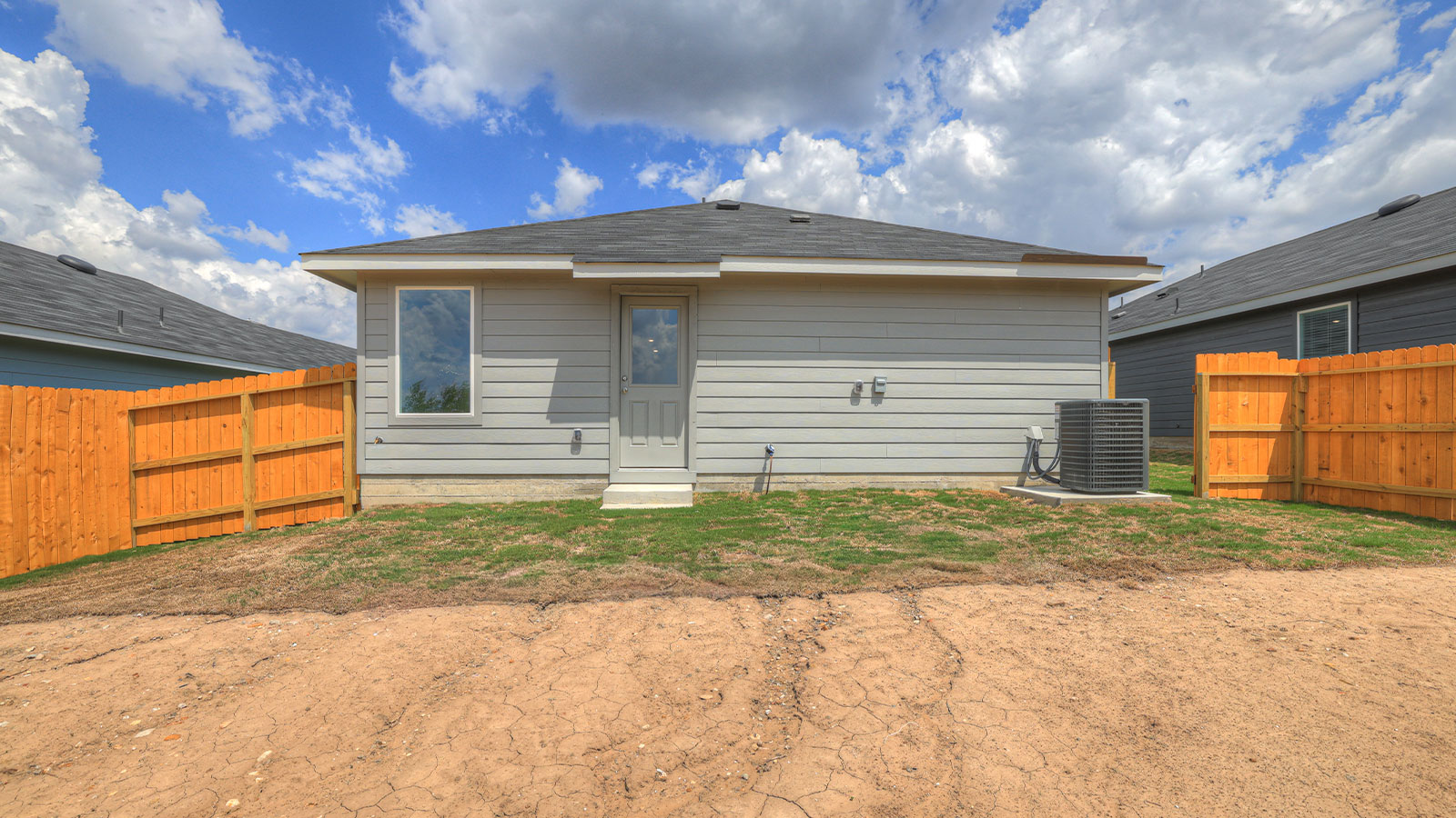 Backyard with sod and privacy fence.