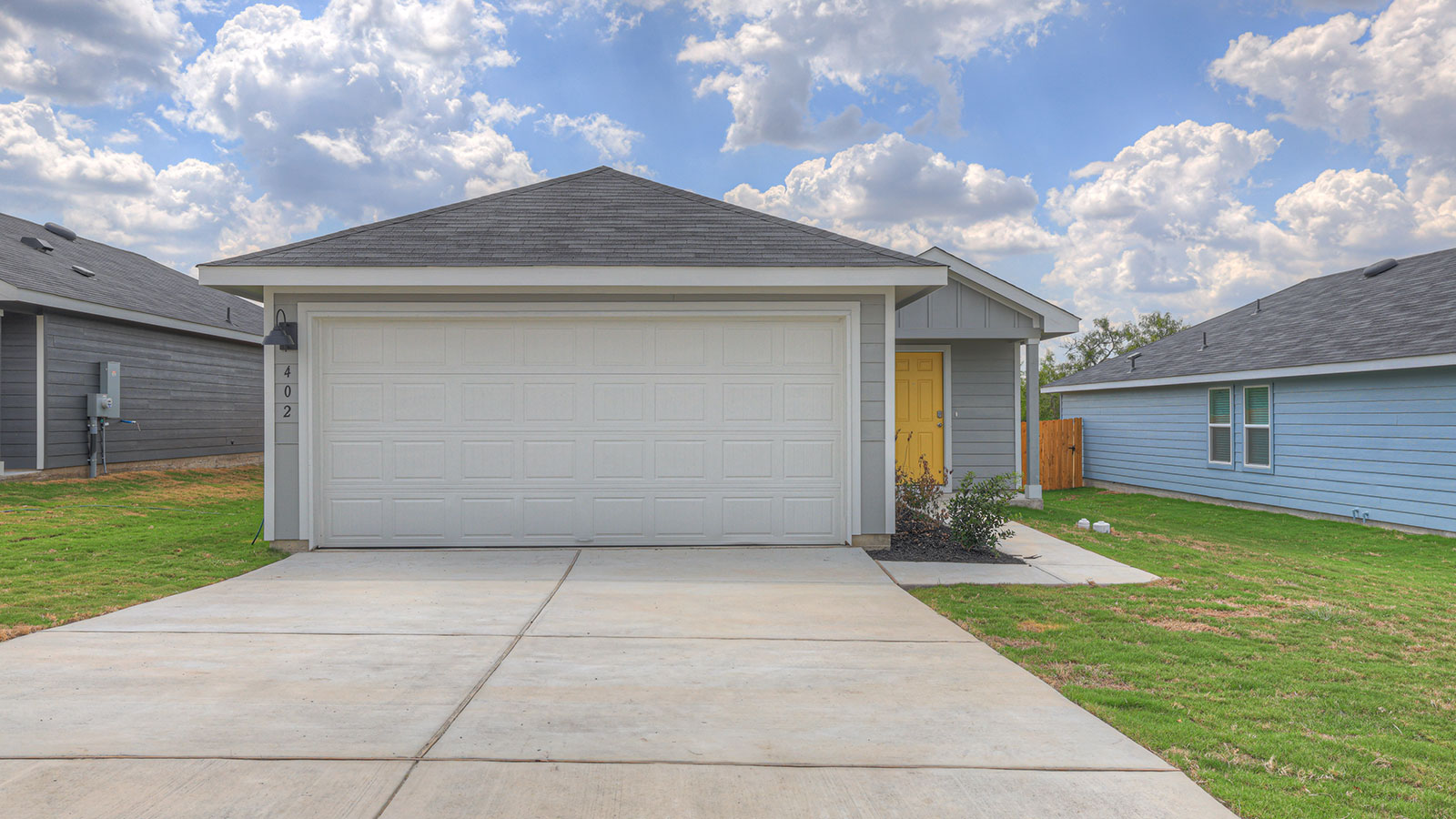 Single-story farmhouse with 2 car garage.