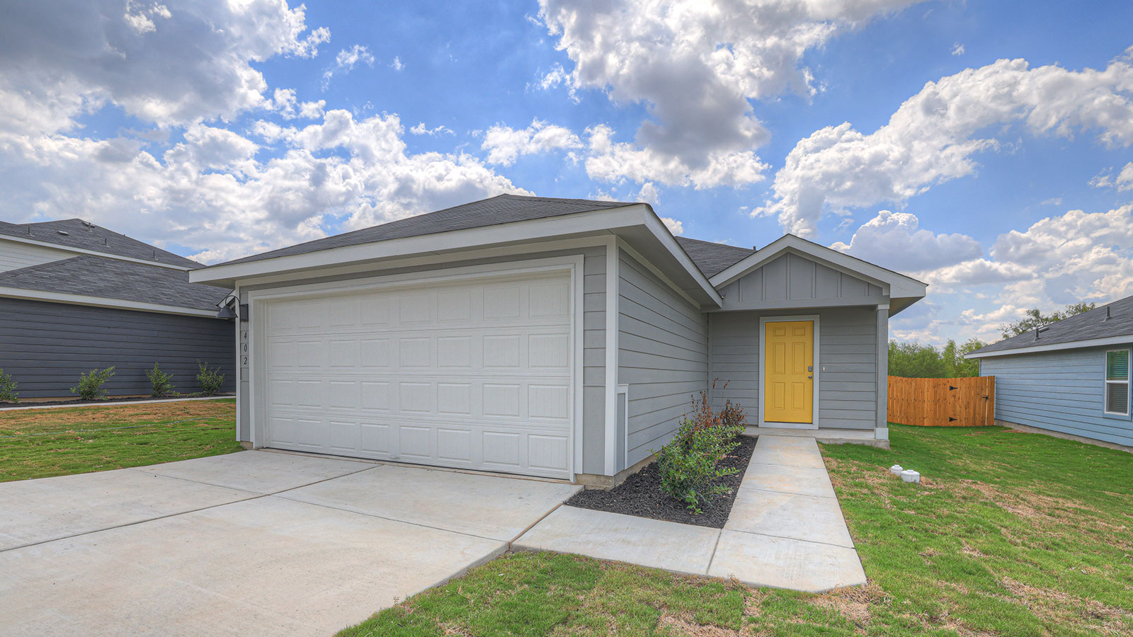 Single-story farmhouse with 2 car garage.