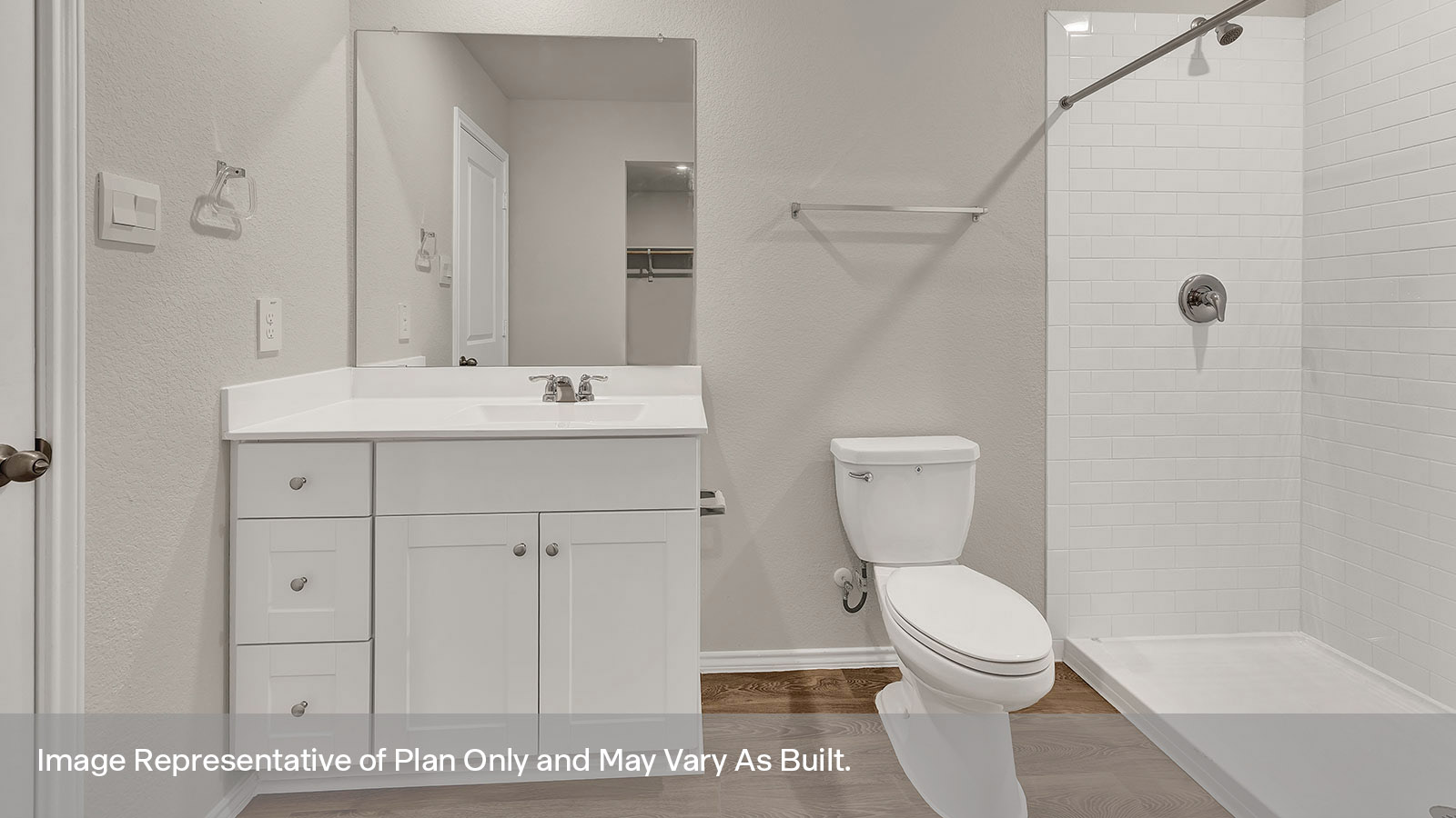 Hall bathroom with single-sink vanity, toilet, and tub with tile surround.