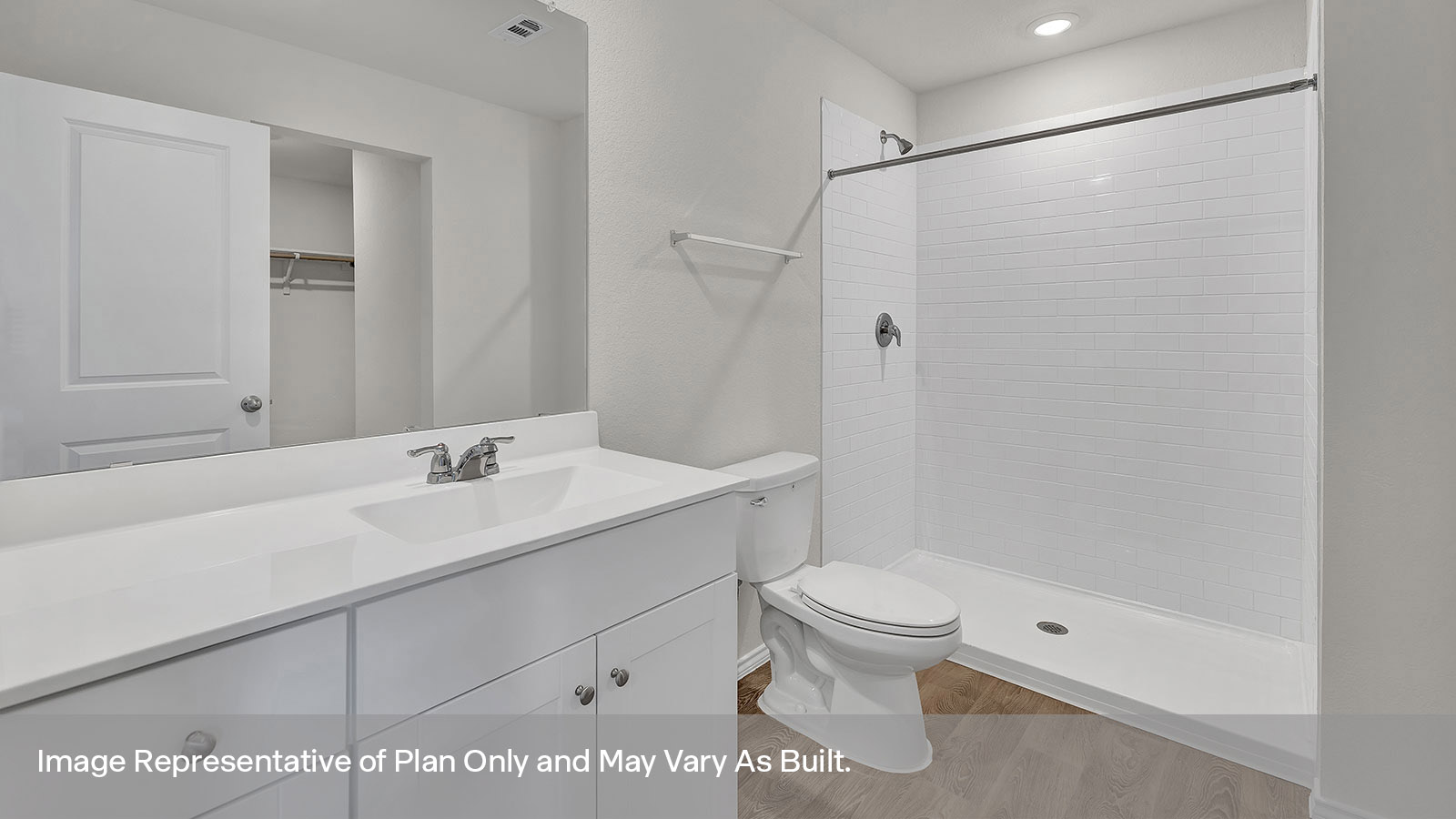 Main bathroom with vanity, toilet, and tiled shower.