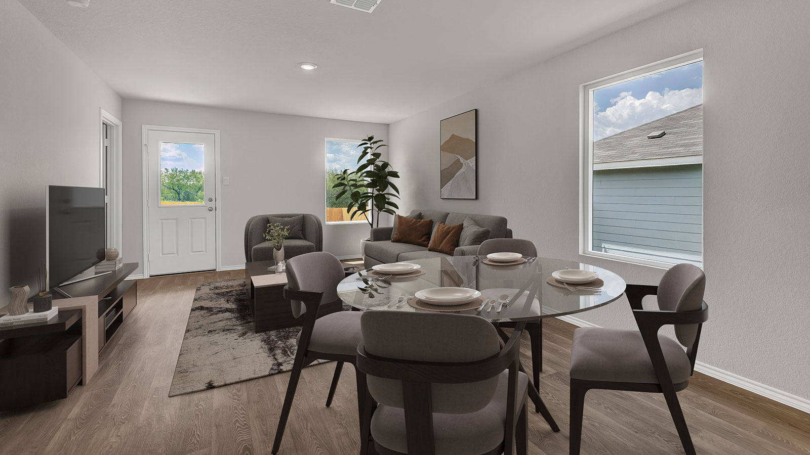 Dining room and living room with vinyl flooring, 2 windows, and a half lite exterior door.