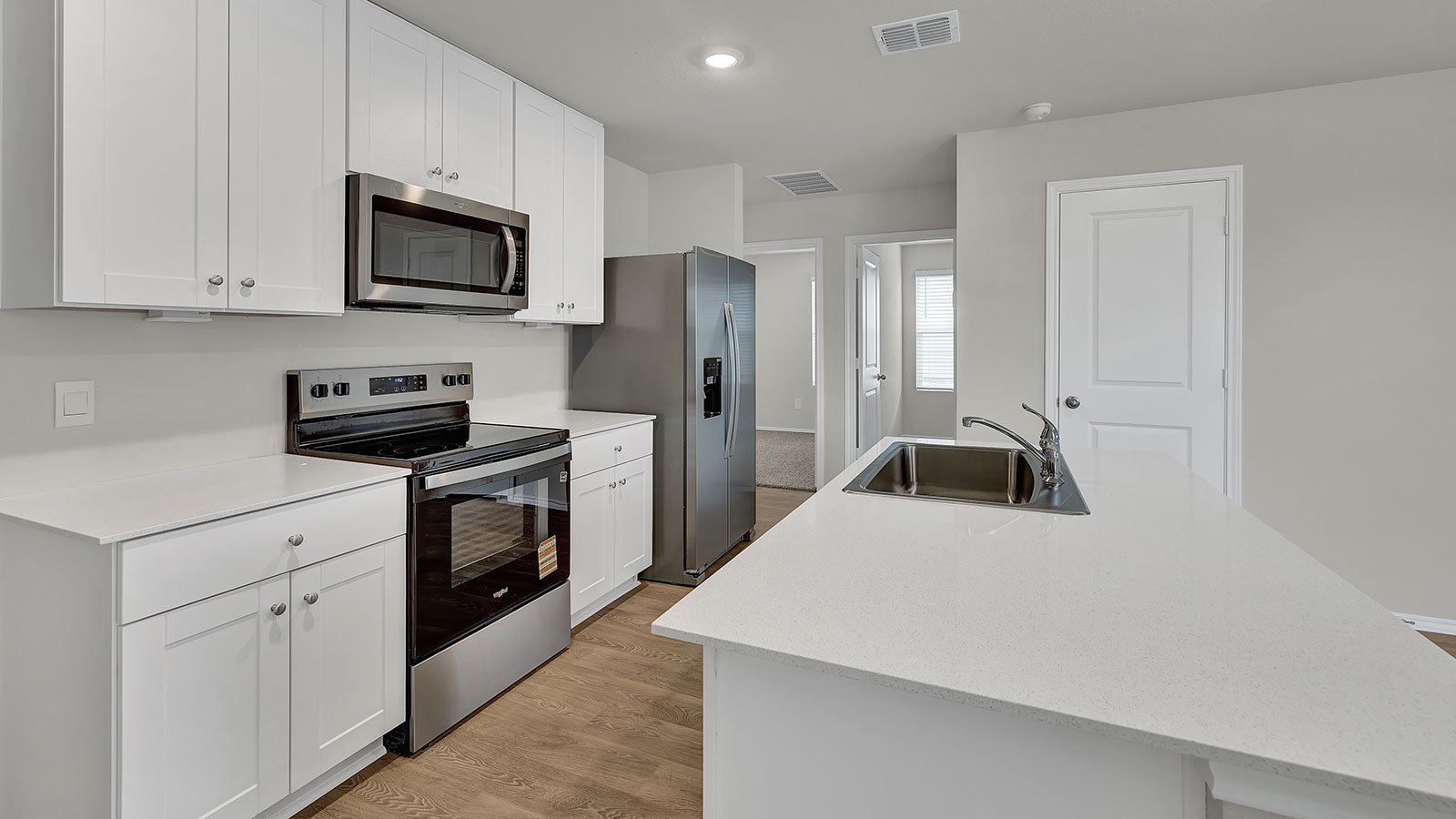 Kitchen with kitchen island and white cabinets.