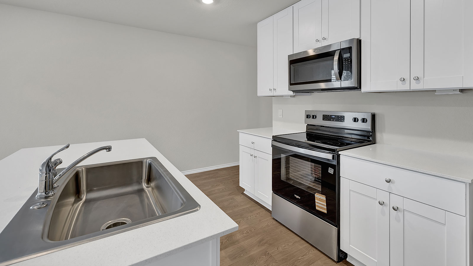Kitchen with quartz countertops and stainless steel appliances.