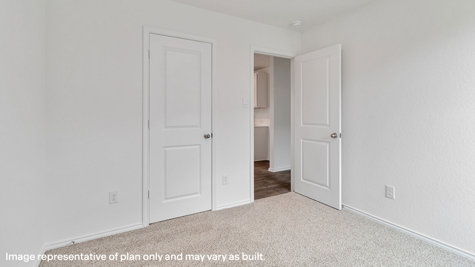 Secondary bedroom with carpeting and bathroom entry.