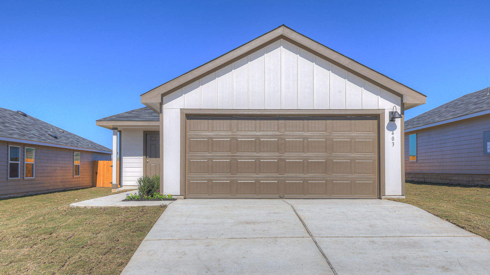 Single-story farmhouse with 2 car garage.