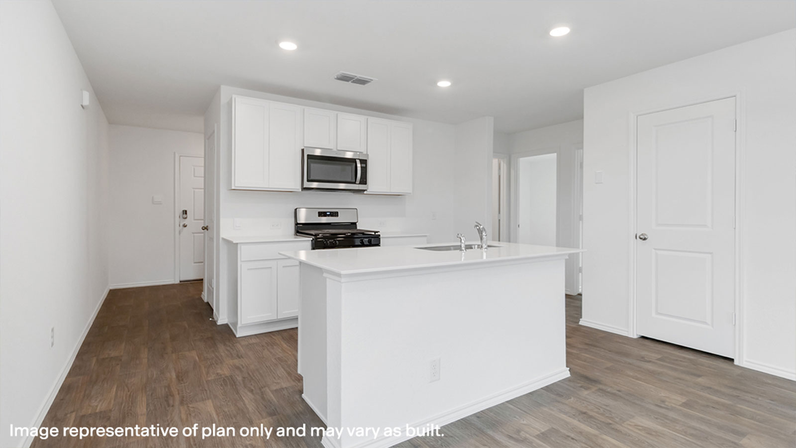 Kitchen with kitchen island and white cabinets.