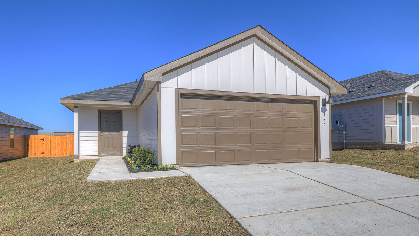 Single-story farmhouse with 2 car garage.