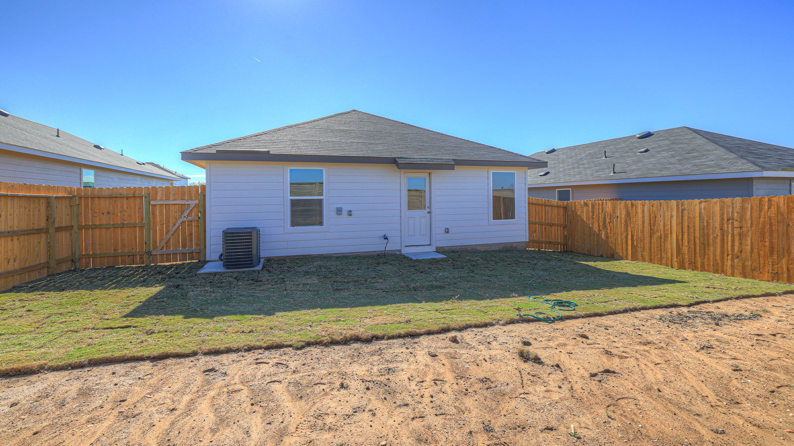 Partially sodded yard with privacy fence