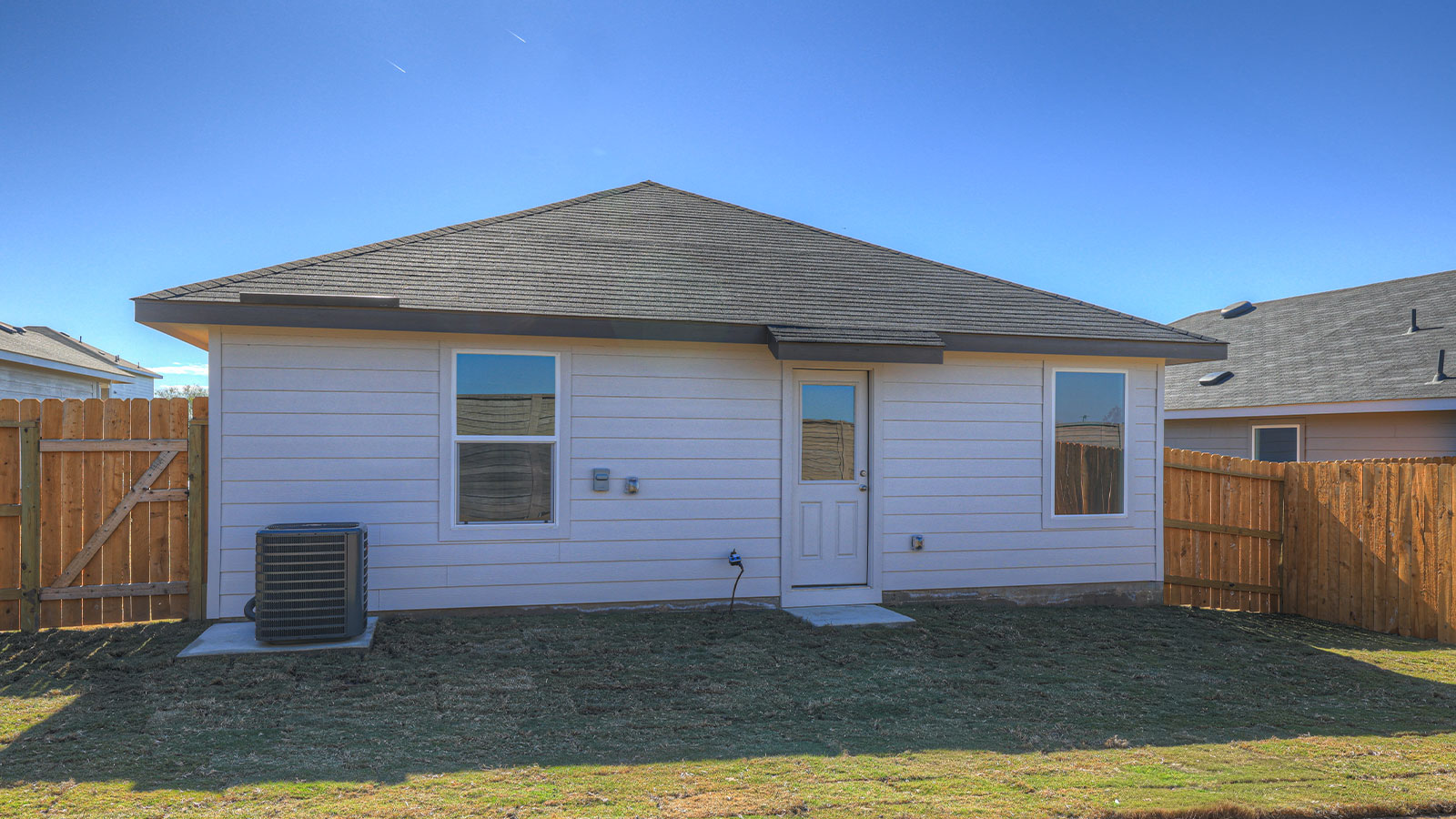 Partially sodded yard with privacy fence