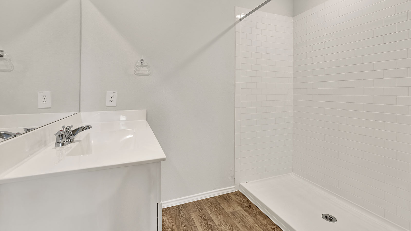 Main bathroom with single sink vanity and closet entry.