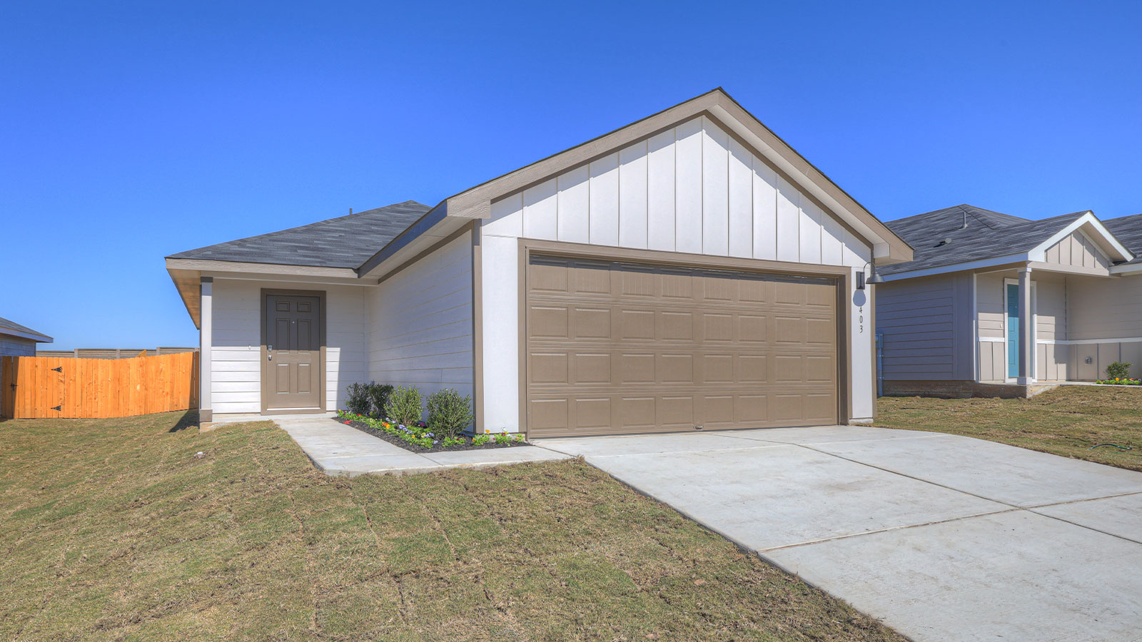Single-story farmhouse with 2 car garage.