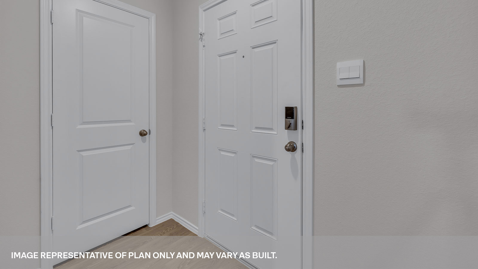 Entryway with vinyl flooring and front door.