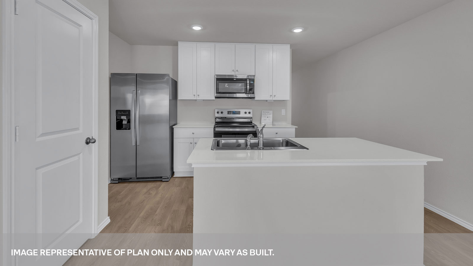 Kitchen with kitchen island and entry hallway.