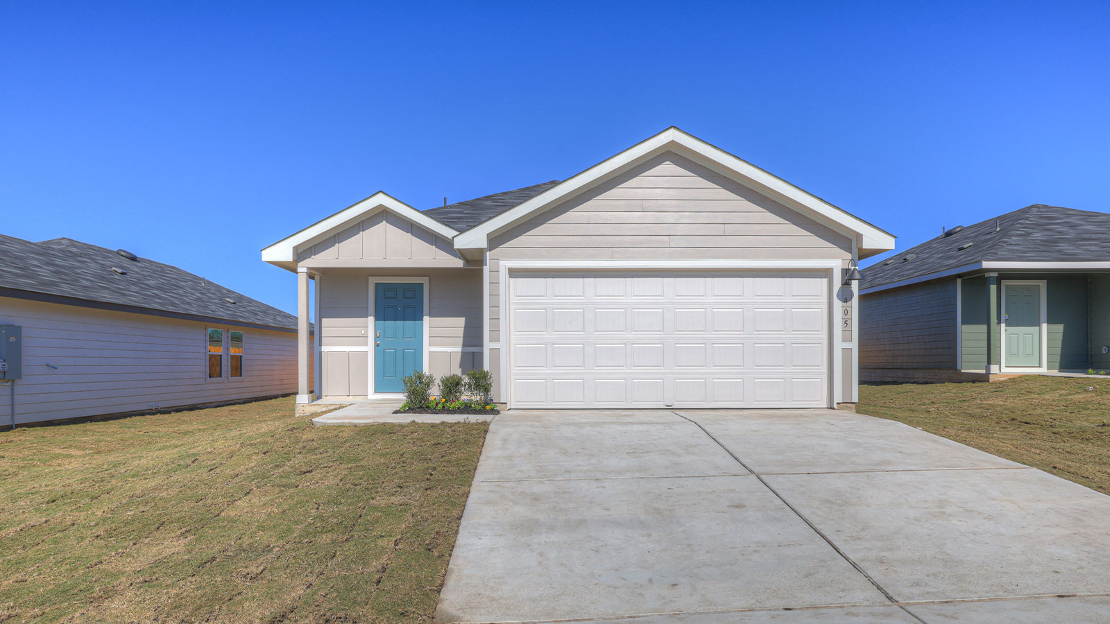 Single-story farmhouse with 2 car garage.