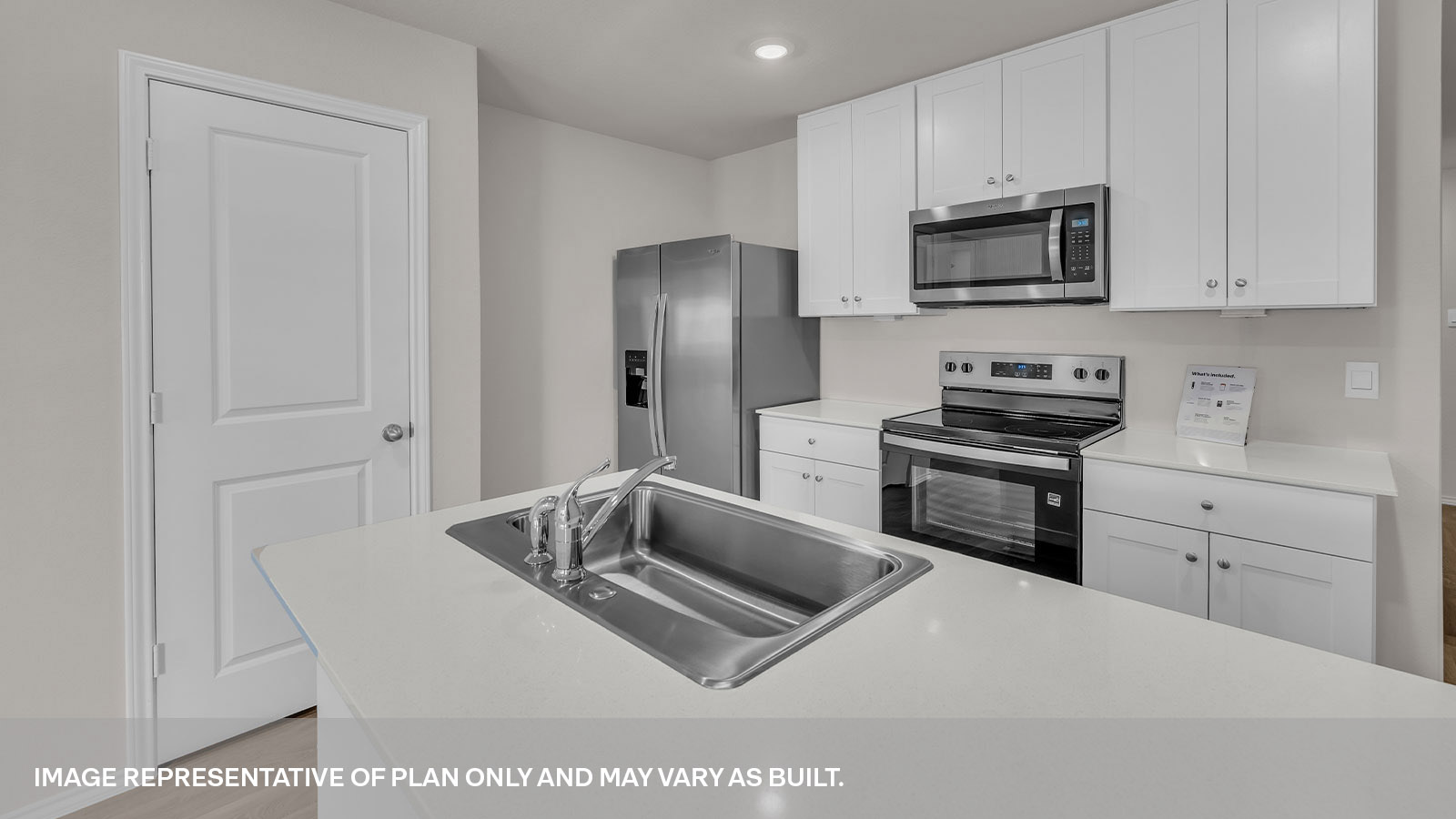 Kitchen with kitchen island and white cabinets.