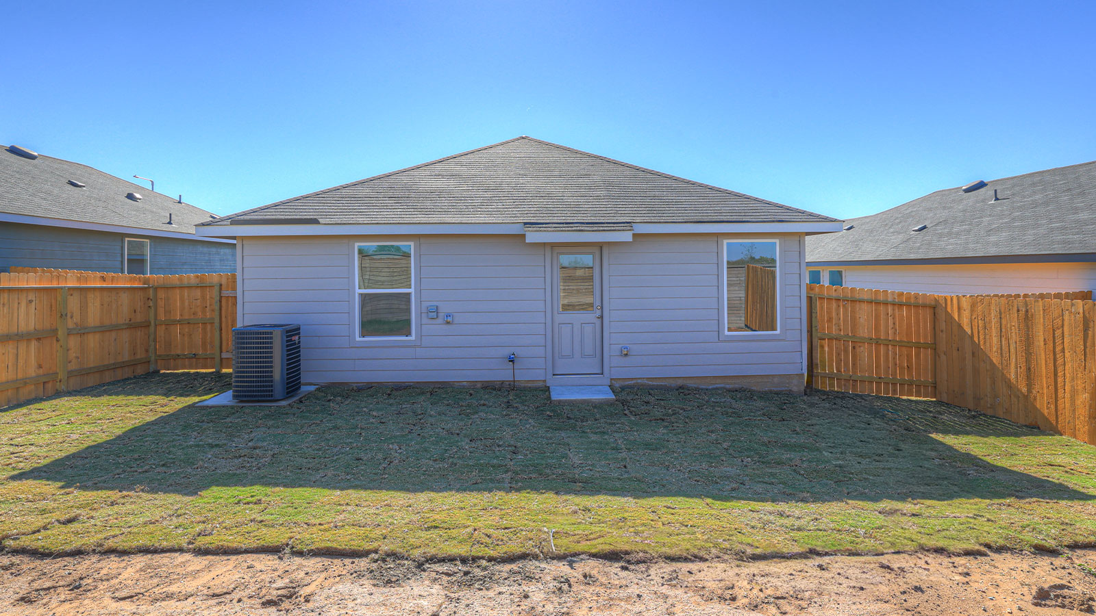 Backyard with sod and privacy fence.