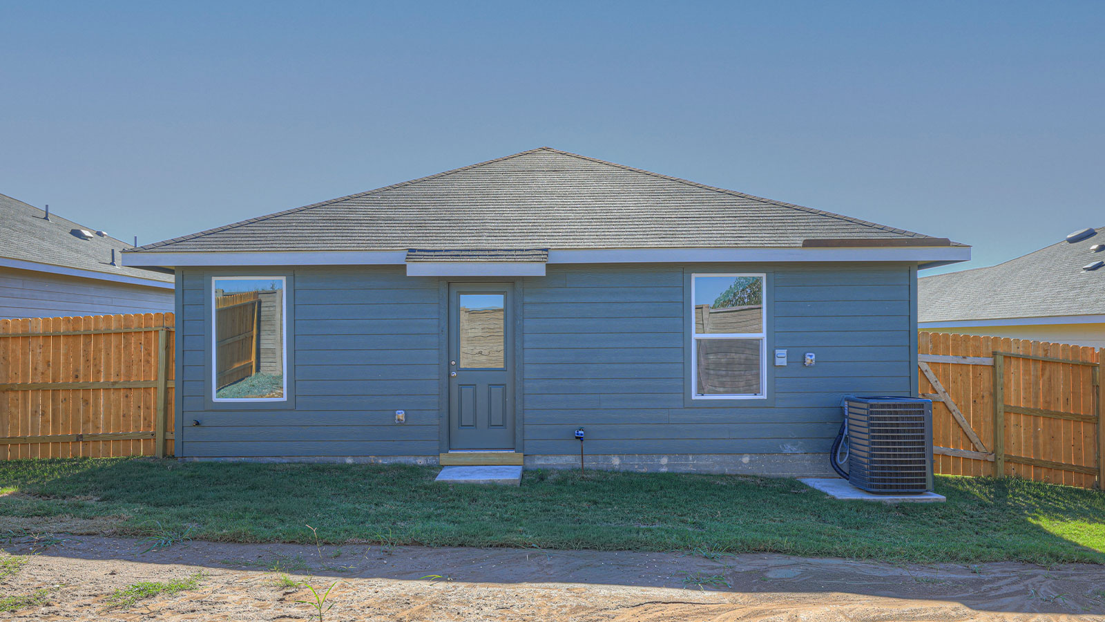Backyard with sod and privacy fence.
