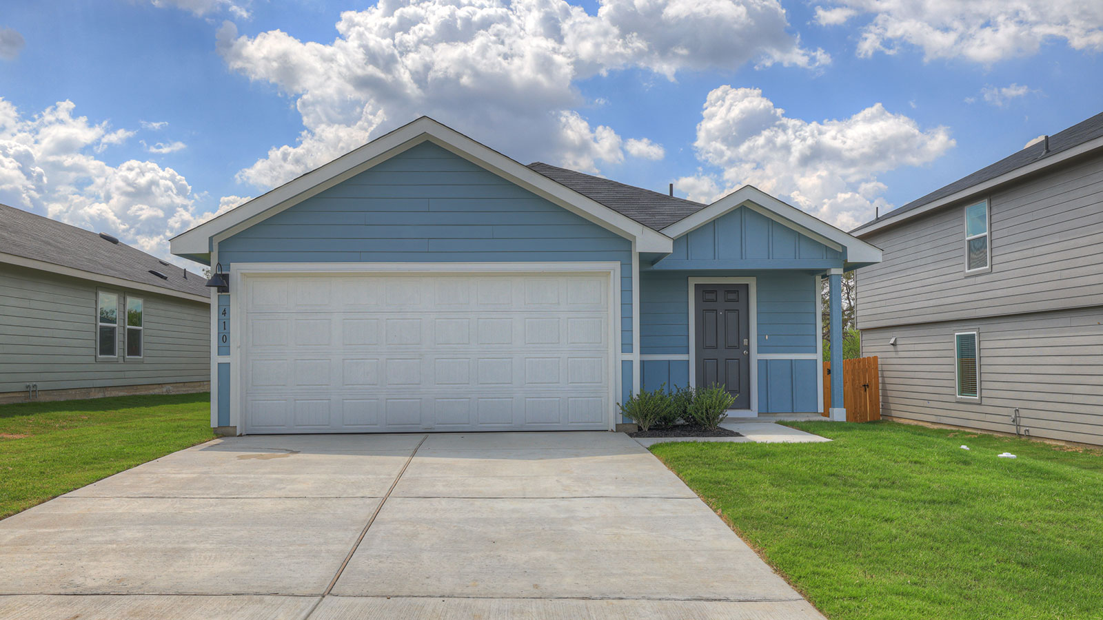 Single-story farmhouse with 2 car garage.