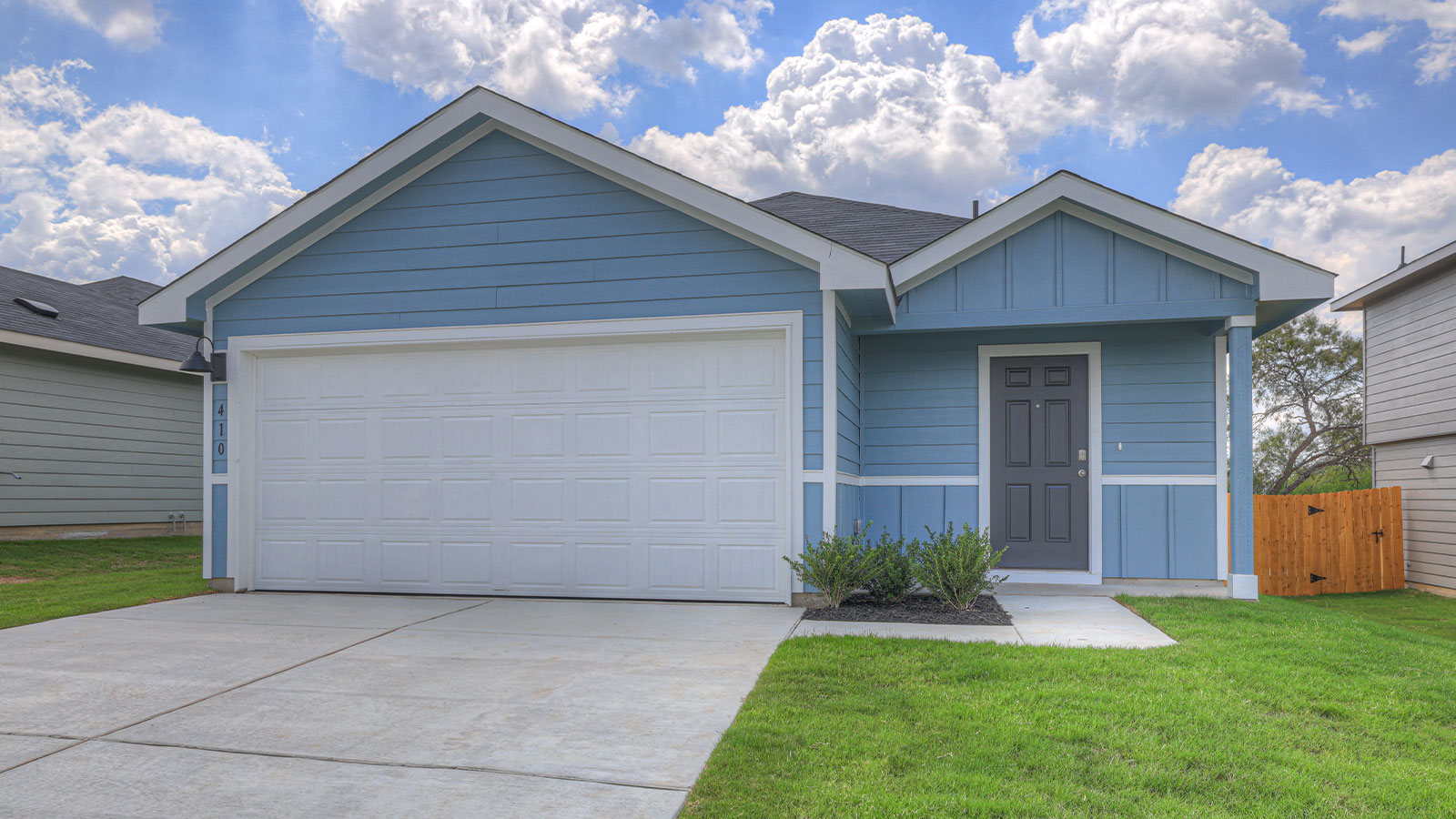 Single-story farmhouse with 2 car garage.
