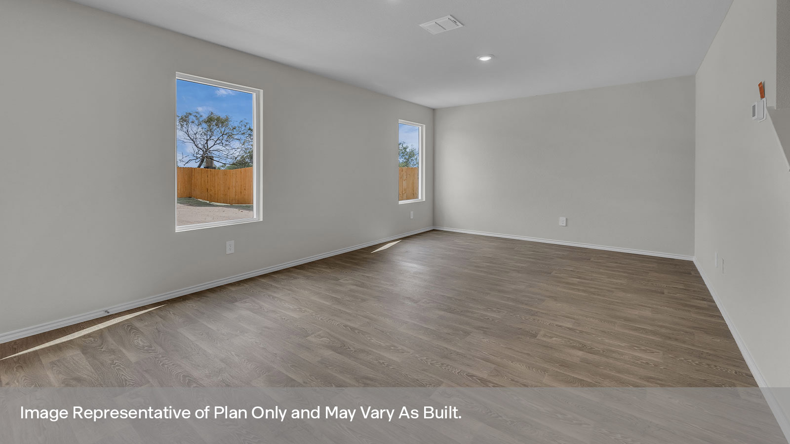 Living room with vinyl flooring, one window, and a half lite exterior door.