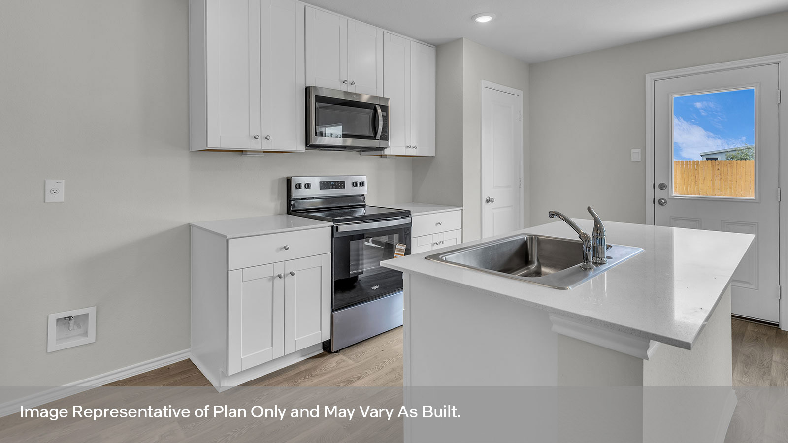 Kitchen with kitchen island and white cabinets.
