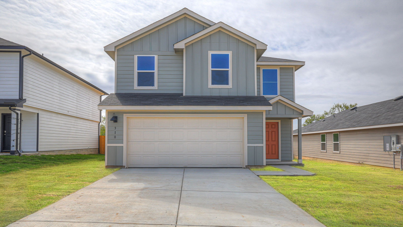 Two-story farmhouse exterior photo with 2 car garage.