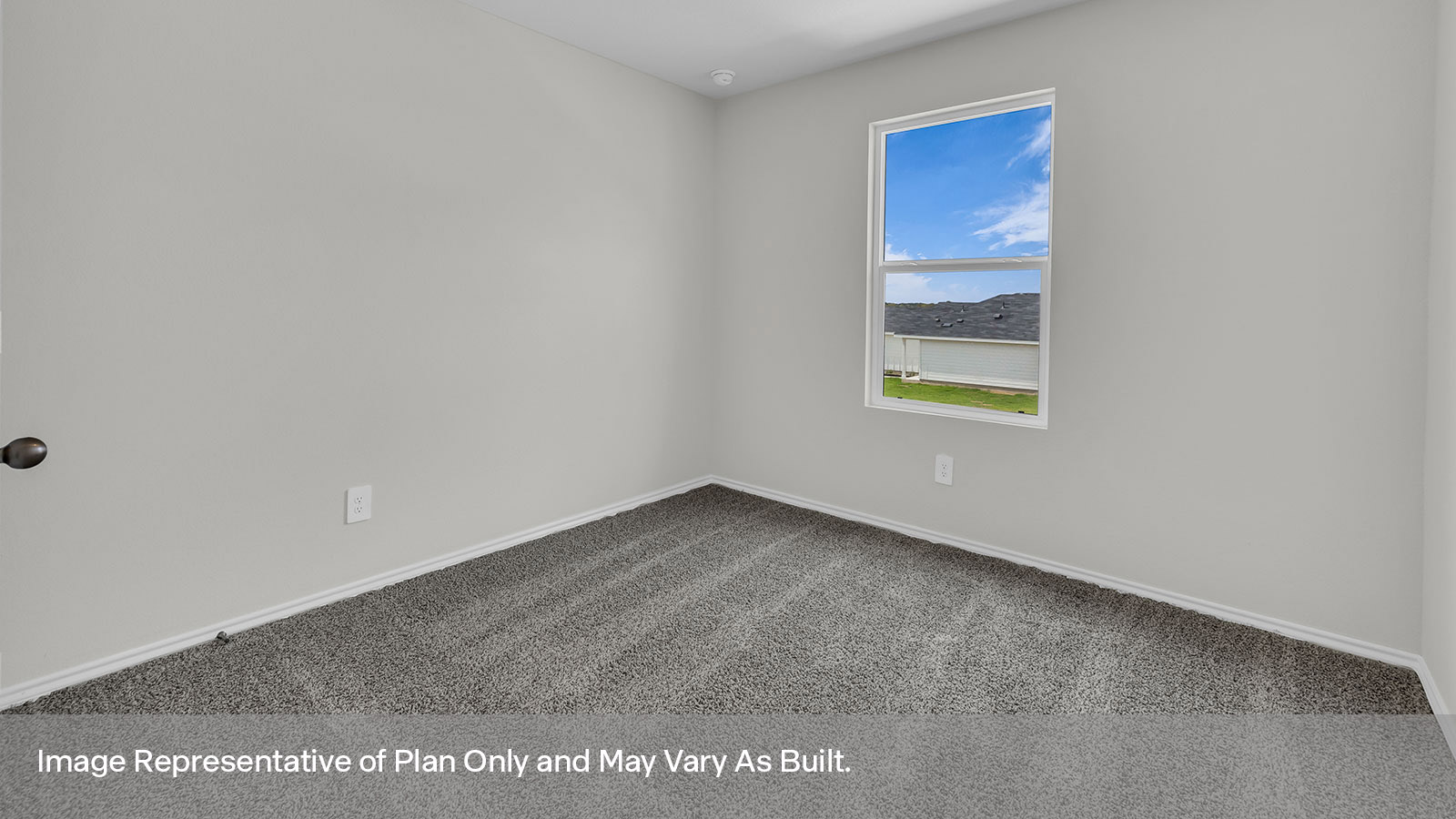 Bedroom with carpeting and one window.